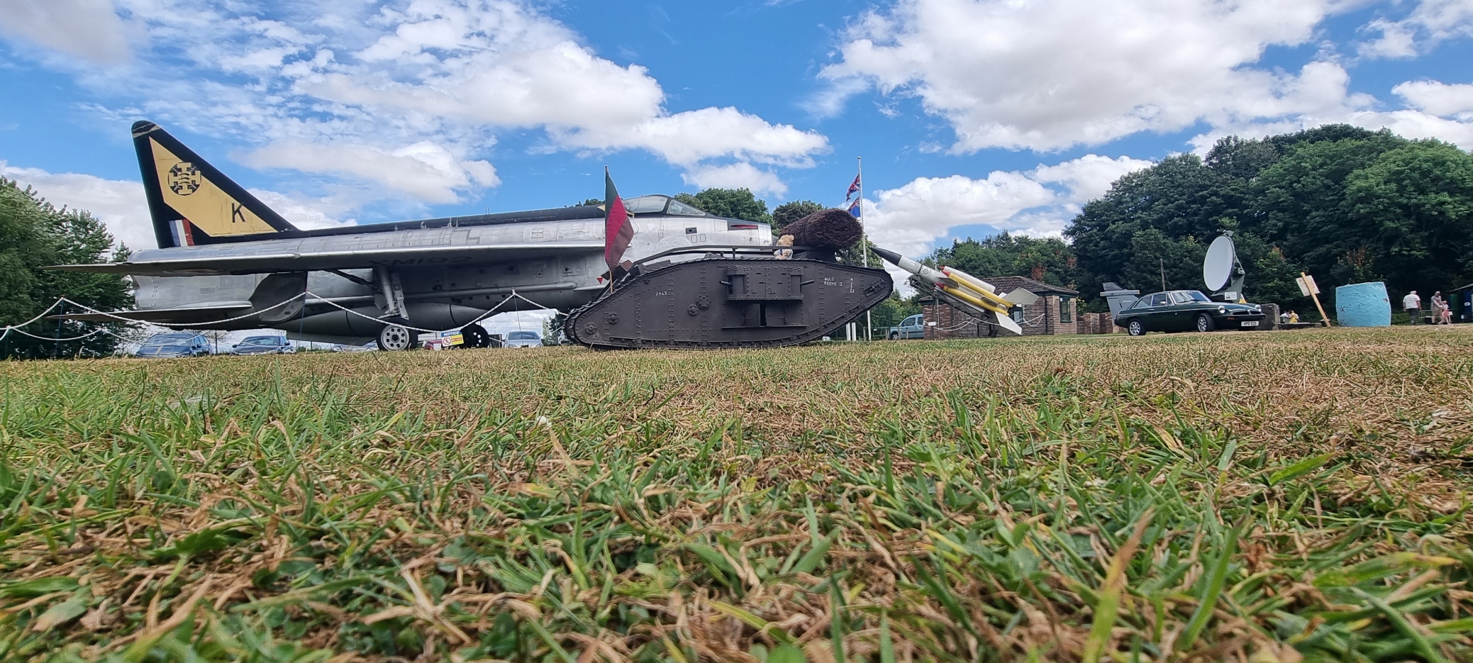 Visitors exploring aircraft and military exhibits at Thorpe Camp