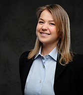 portrait-smiling-blonde-businesswoman-formal-dressed-isolated-dark-textured-background.jpg