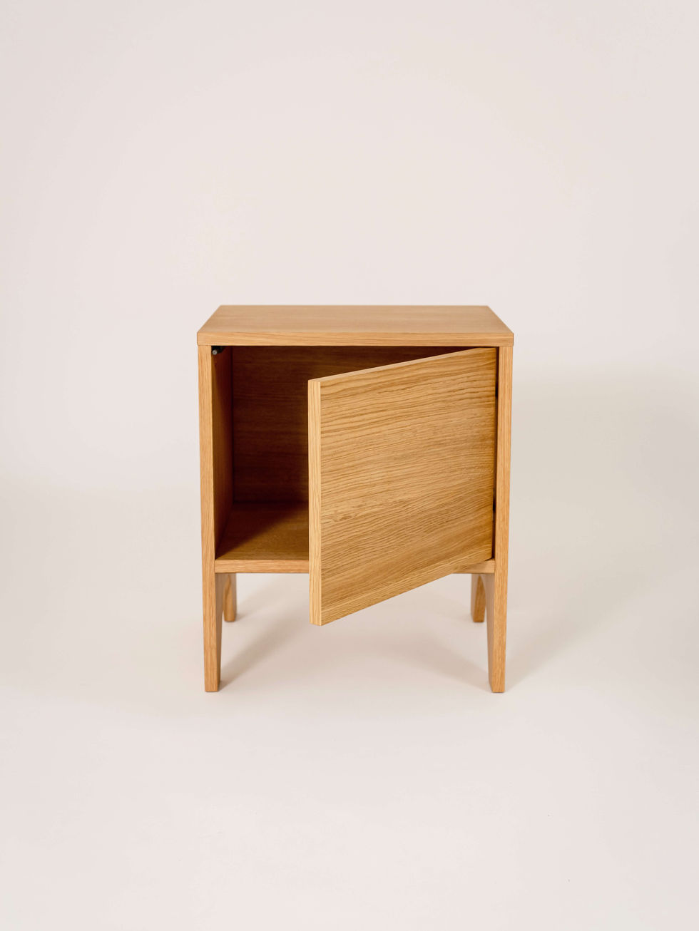 Wooden cabinet with open door and shelf