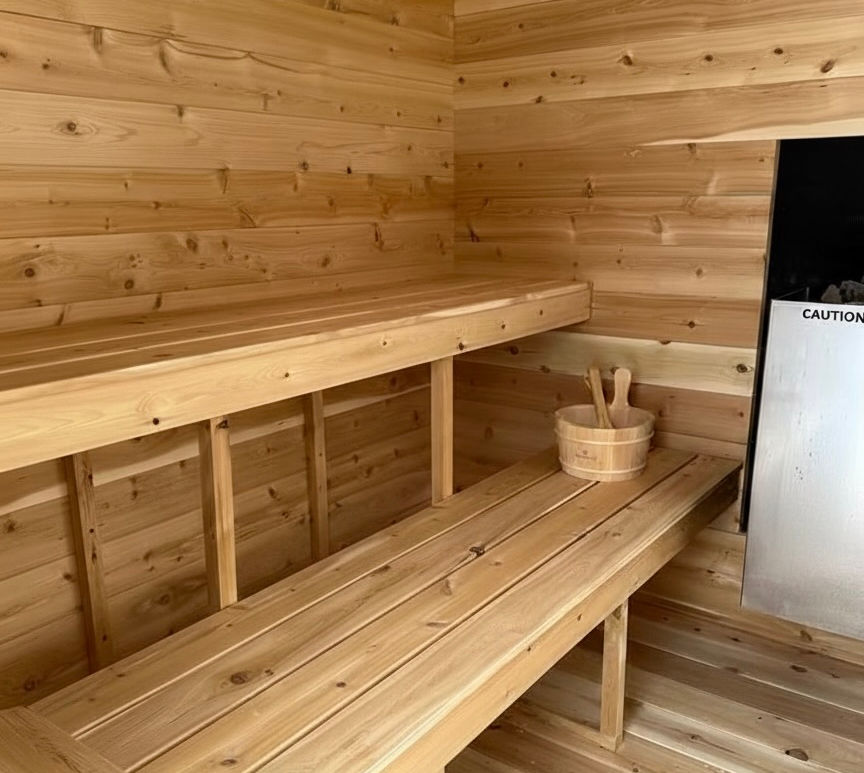 External Load Wood Stove or Harvia Electric Stove
Sauna Rocks
Bucket and Ladle
Cedar Head Rests x 2
Towel Hooks
Vented
2 Level Back Wall Bench Seating 
Tempered Glass Door Insert x 1
Metal Roof

$7800

Lighting System: LED Lighting Kit (+750)