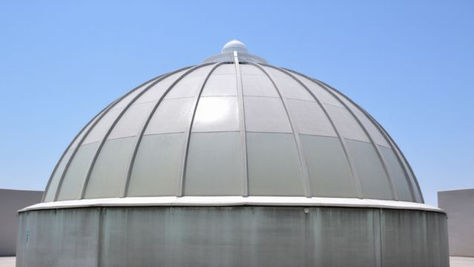 Large dome-shaped GRP cover enclosing a water tank, designed for weather protection and odour control.