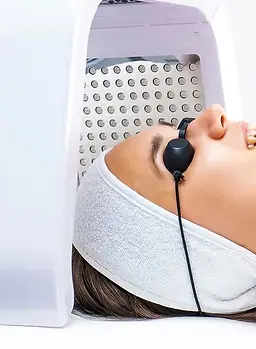 Led phototherapy for the face_ Phototherapy in cosmetology_ A beautiful young woman in a s