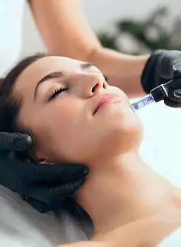 Shot of cosmetologist making mesotherapy injection with dermapen on face for rejuvenation