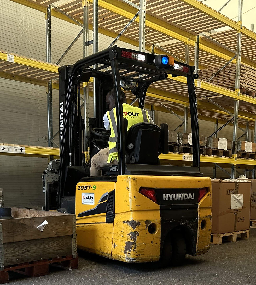 Warehouse operator driving a counterbalance forklift to move pallets during training session