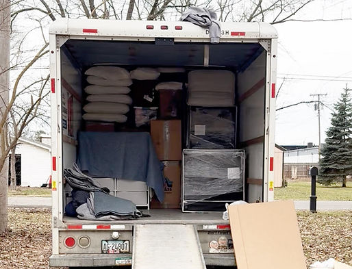 Tightly packed moving truck loaded with furniture and boxes for an interstate move from Michigan