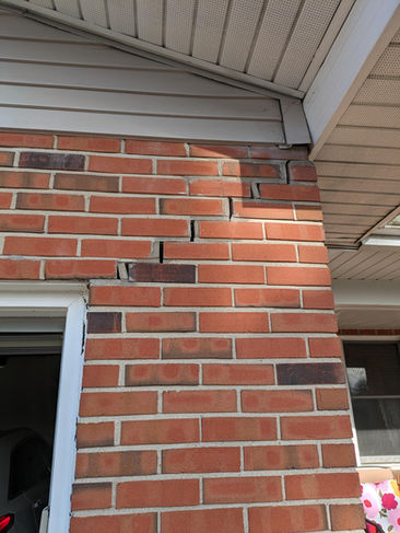 Brick wall with cracks needing foundation repair