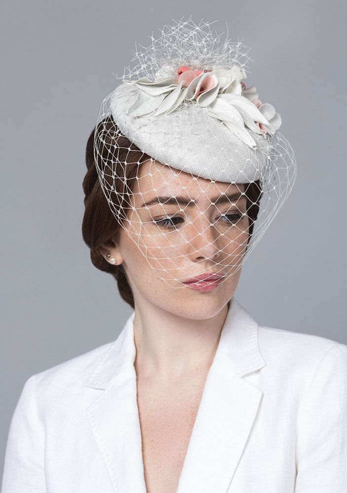 Thumbnail: bridal white pillbox hat with pink flowers and veiling