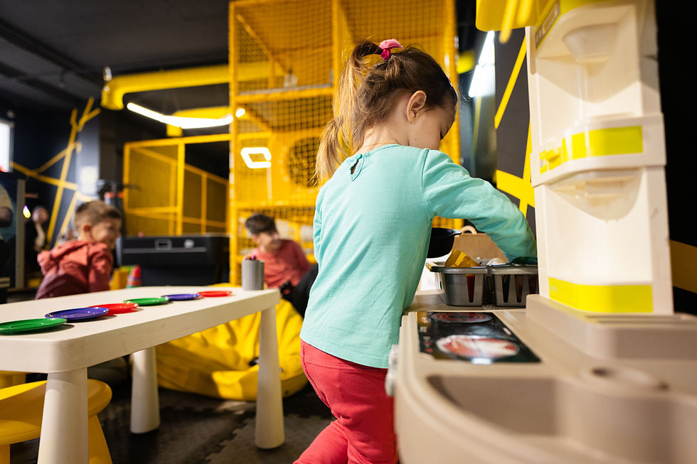 baby-girl-playing-in-kids-kitchen-at-children-play-2023-11-27-05-24-00-utc.jpg