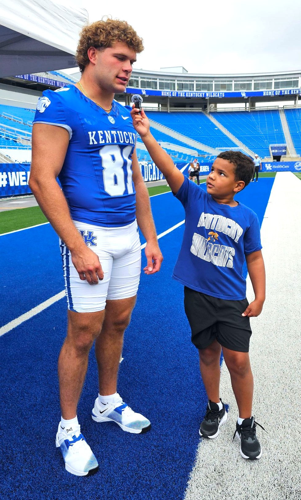 Kentucky tight end Willie Rodriguez (left) participates in the recent UK Football Media Day festivities at Kroger Field, where he was interviewed by special guest "Kid Reporter" Ricky Lumpkin III. (Photo by Jamie H. Vaught)