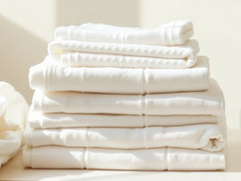 fragrance-free laundry routine for sensitive skin with neatly folded white towels