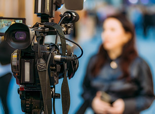 Media interview with a businesswoman at a trade fair on business and entrepreneurship.jpg