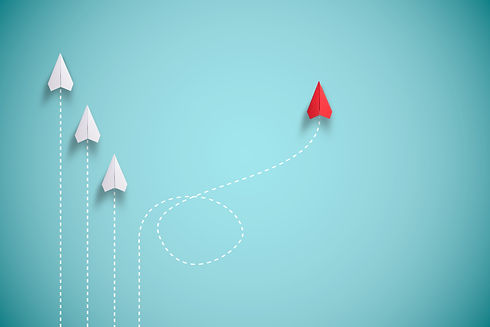 Red paper plane out of line with white p