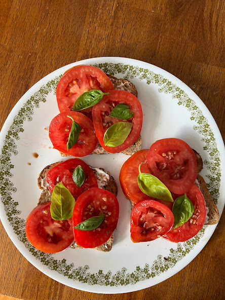 Sliced tomatoes and basil on toast