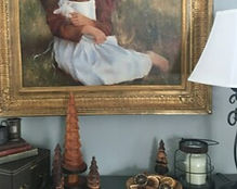 Wooden trees displayed in a home with other decor.