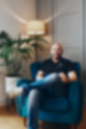 Photo of Andy Selway, Clinical Hypnotherapist and heyford small business network founder sat in a chair facing forward and smiling