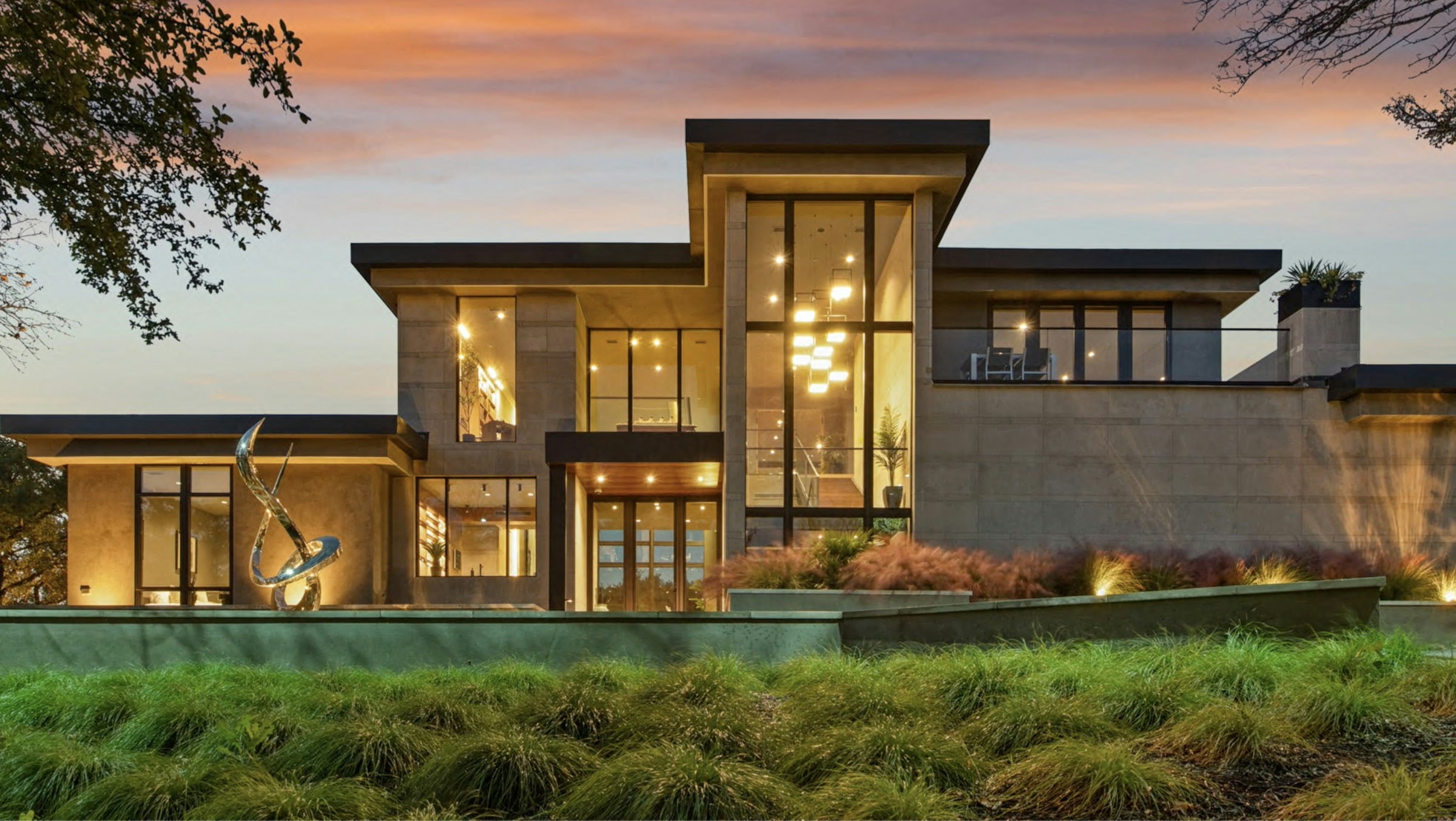 Modern luxury home illuminated at dusk