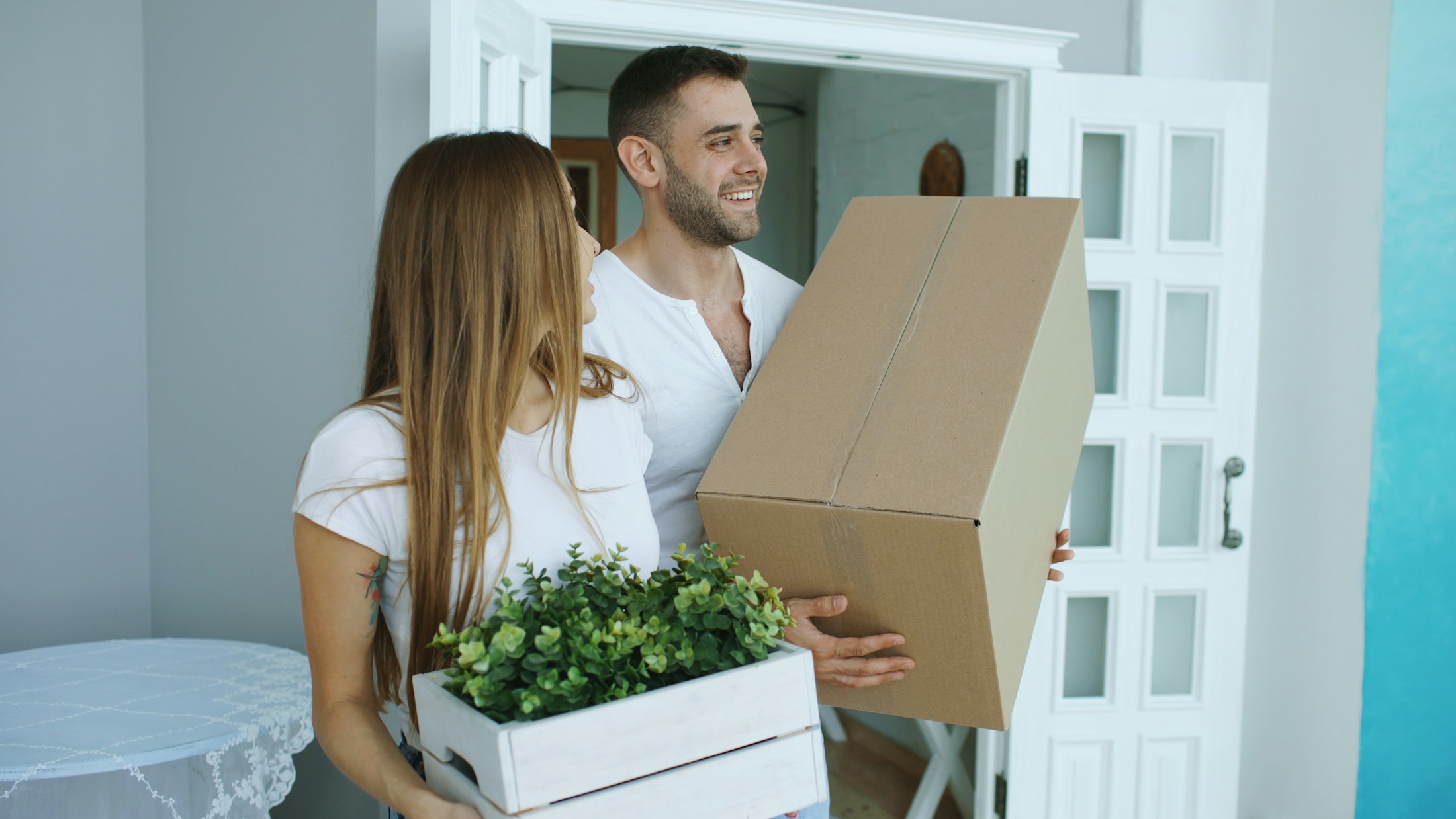 Homeowners carrying moving boxes during a move