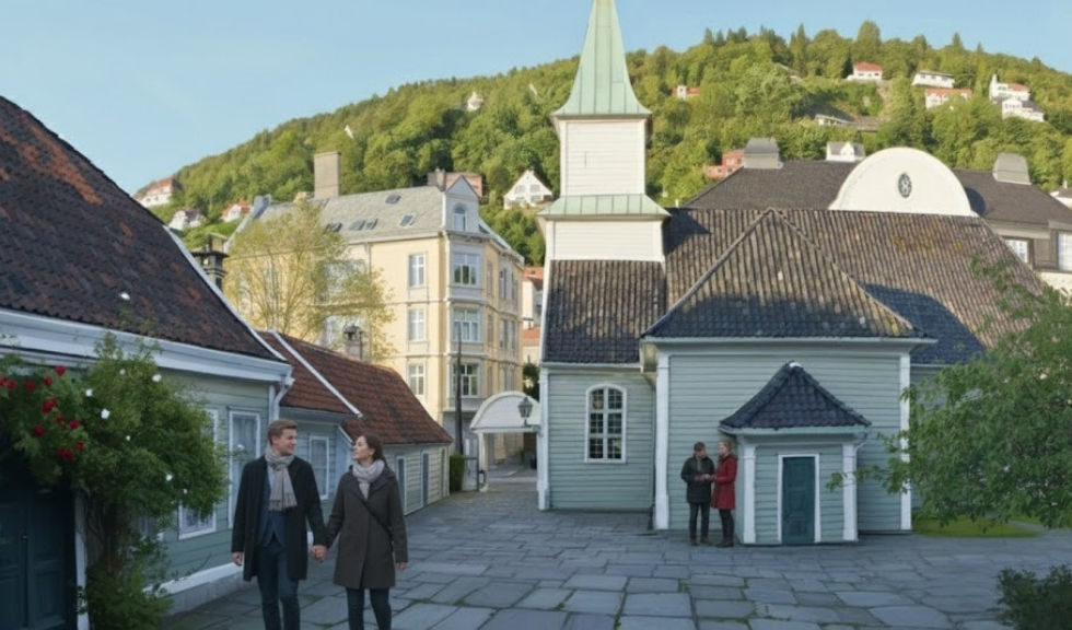 Courtyard at the Bergen Leprosy Museum (St. Jorgen’s Hospital) with historic wooden buildings, a church-like structure, and visitors walking in the foreground.