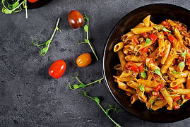 penne-pasta-tomato-sauce-with-meat-tomatoes-decorated-with-pea-sprouts-dark-table.jpg