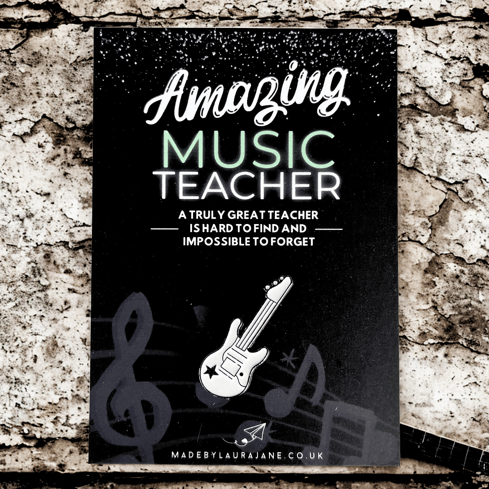 white guitar pin badge on a black card which says Amazing Music Teacher