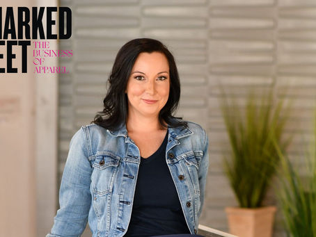 Rachel Erickson in a jean jacket, smirking.