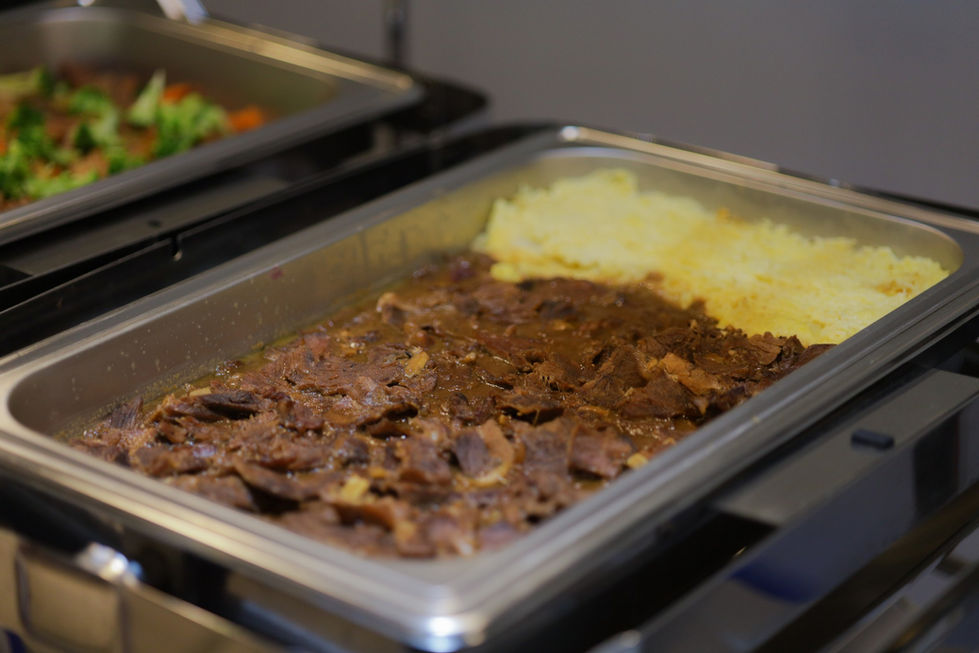 a tray of meat and mashed potatoes on a table