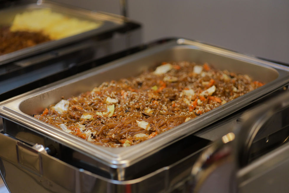 a buffet tray filled with noodles and vegetables