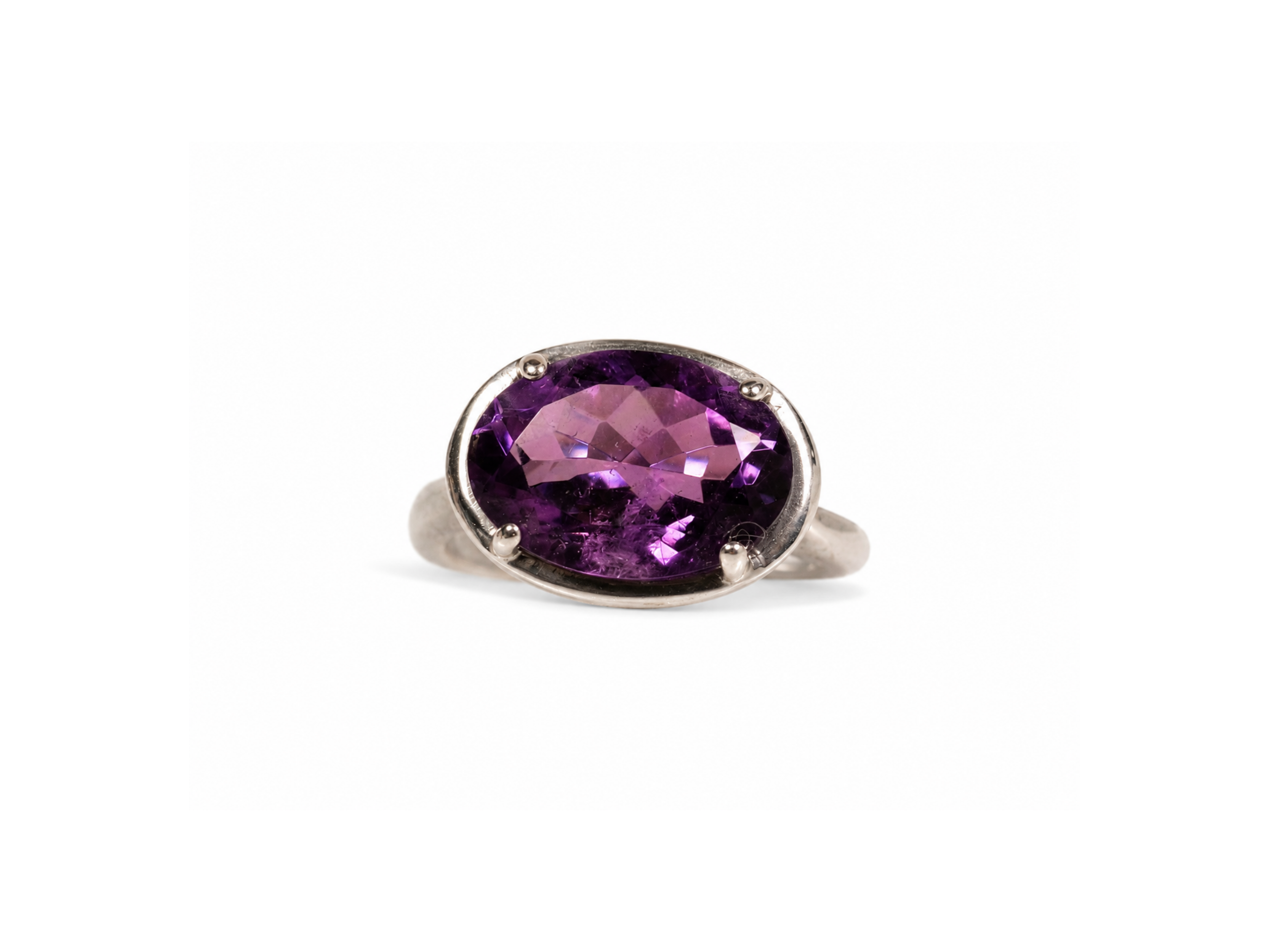 amethyst, oval-cut, purple, gemstone, silver band, polished, elegance, tranquility, spiritual clarity,