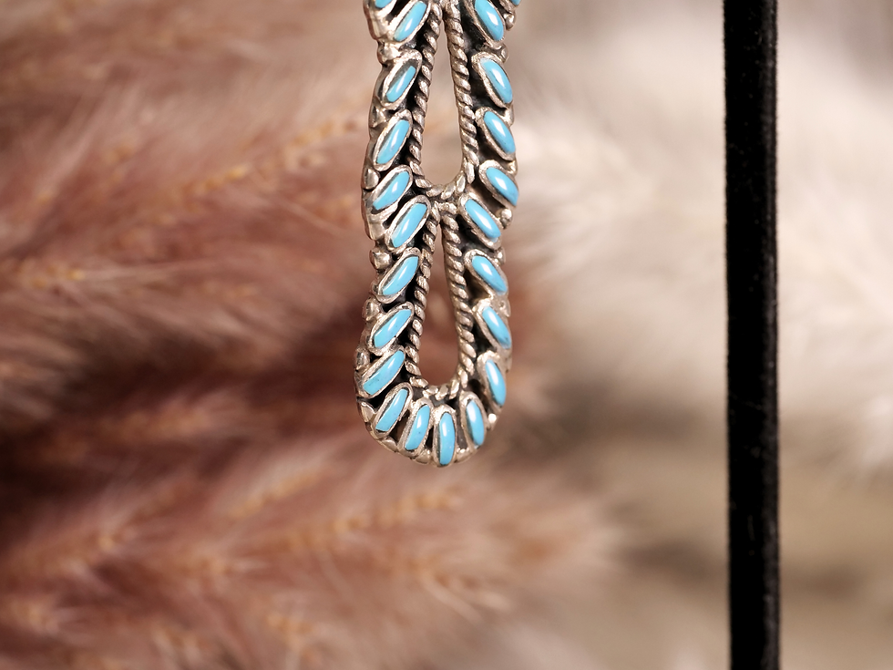Thumbnail: Elegant and eye-catching, these cascading earrings feature vibrant turquoise stones set in sterling silver, designed in an in