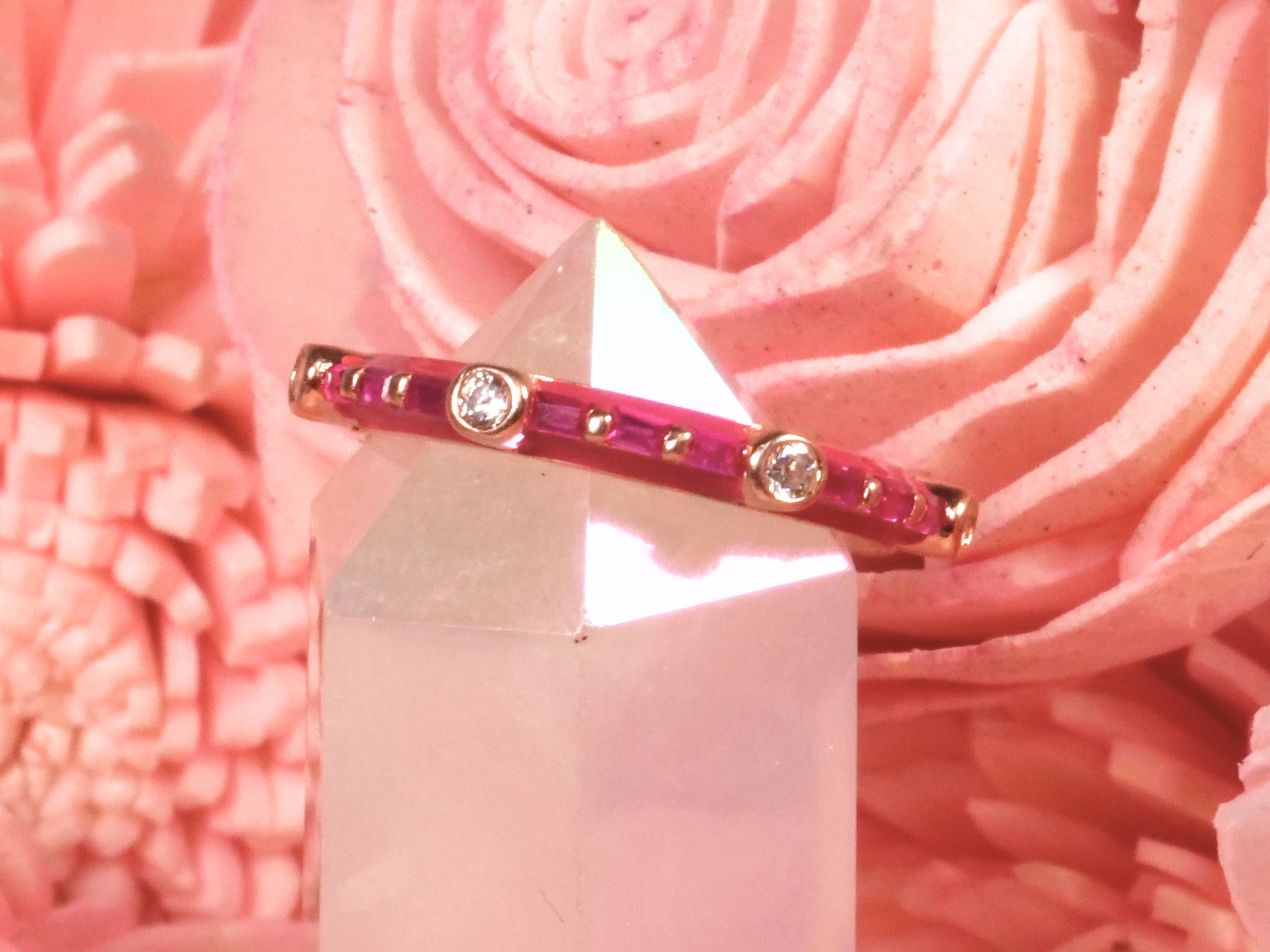 Sterling silver ring with deep pink and circular clear stones for an elegant contrast.