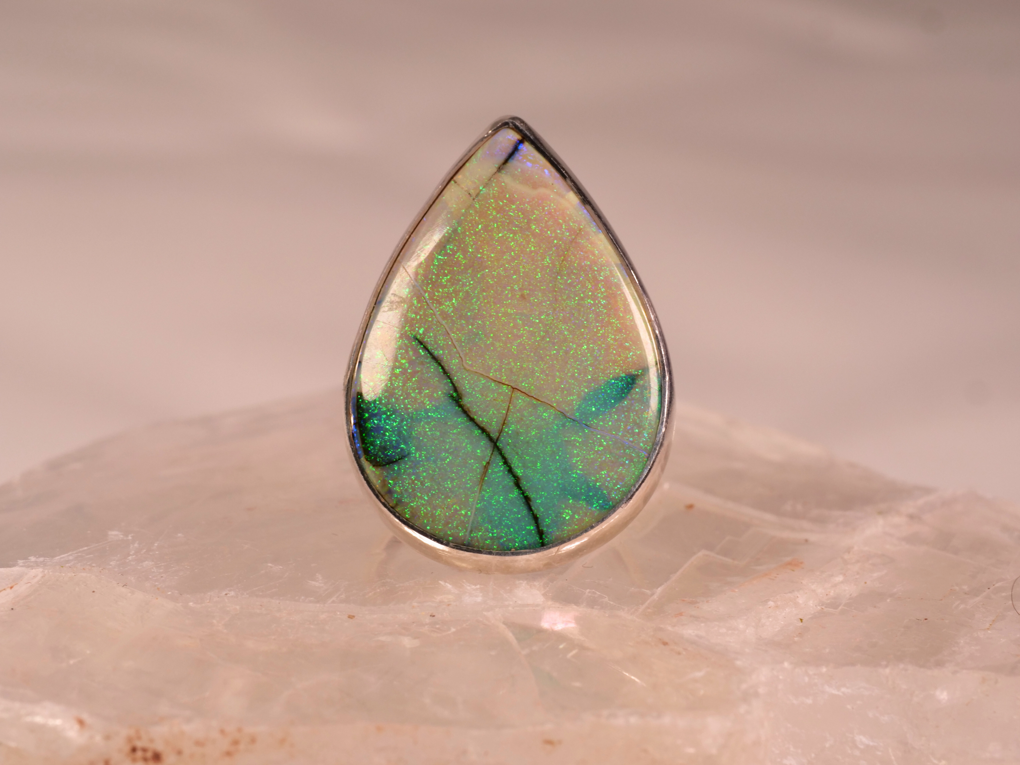 This Prehnite Ring features a stunning pear-shaped gemstone that radiates with soft green hues, creating a serene and calming