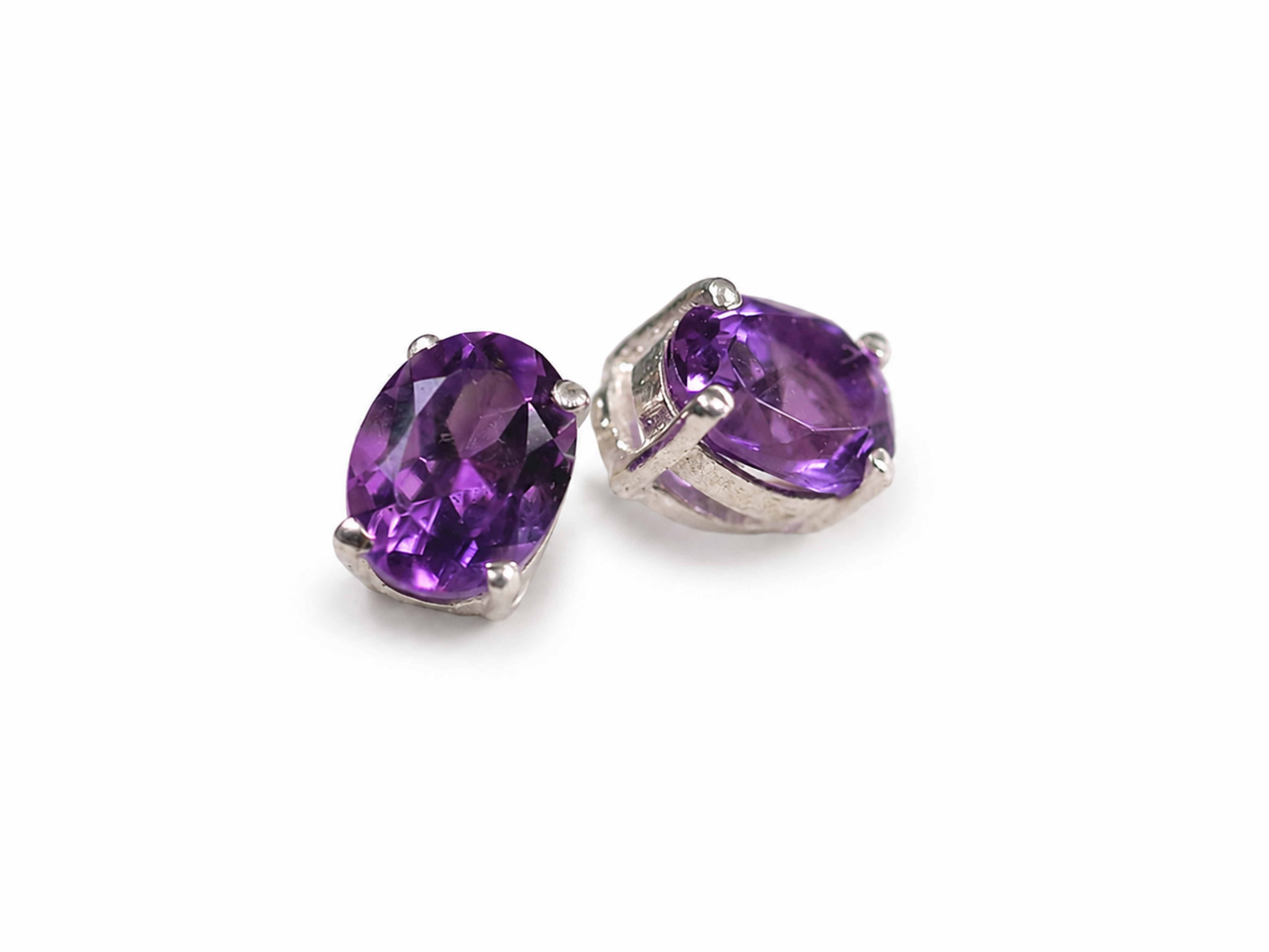 These stunning Amethyst earrings feature vibrant, faceted purple stones that catch the light beautifully from every angle. Se