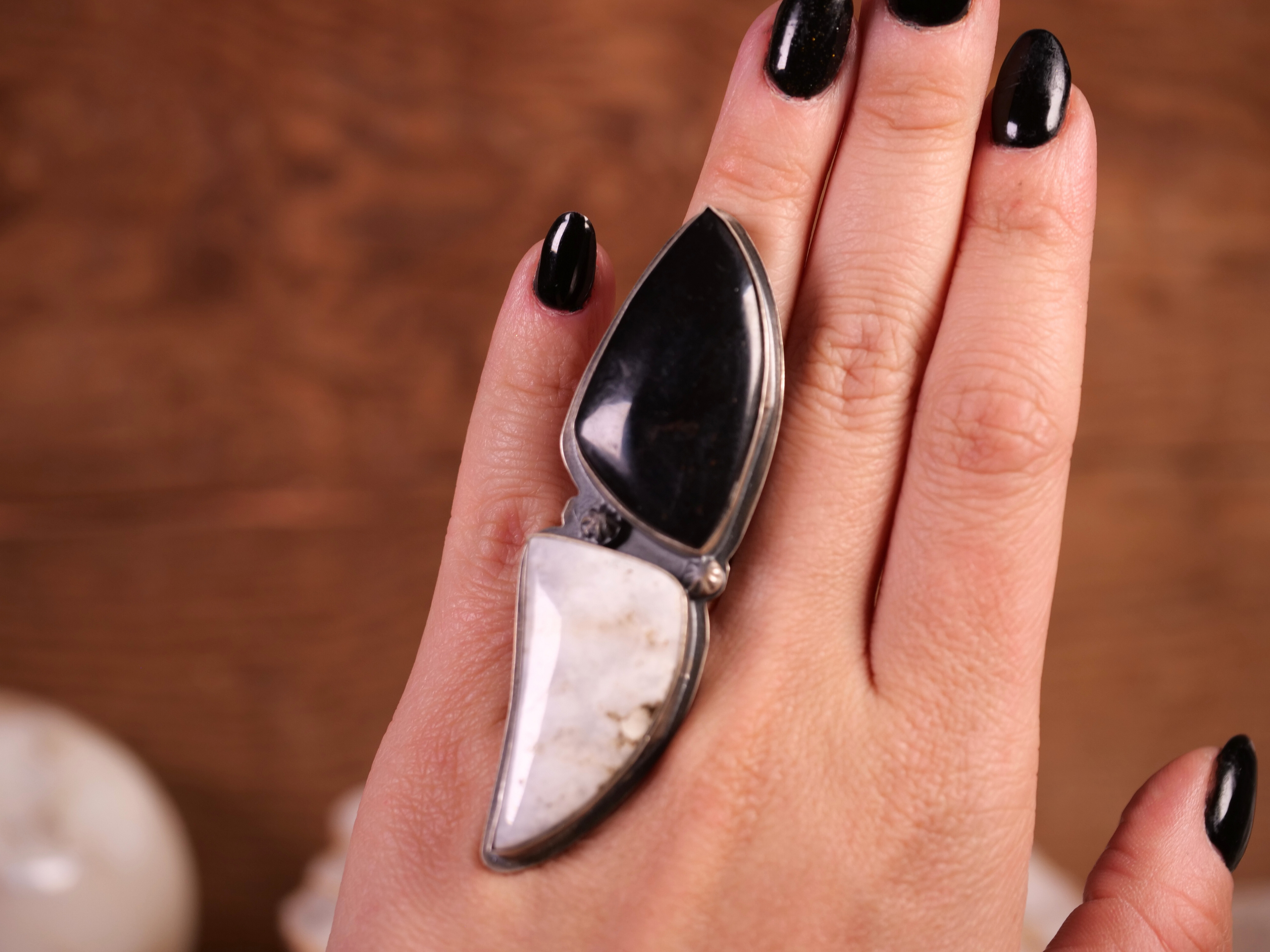 A bold two-stone statement ring featuring contrasting White Buffalo and Black Onyx, set in sterling silver.