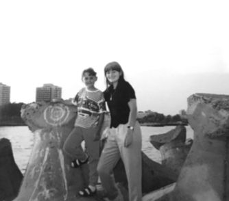 Two people posing near the water on a sunny day. Venture Athletes