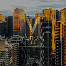 Venture Athletes logo over a cityscape, skyscrapers; Venture Athletes in an urban setting.