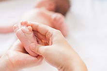Newborn baby receiving foot massage