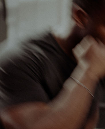 Coach showing a punching move with interio shot of Strength Based studio gym