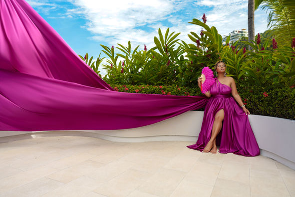 Woman in pink flying dress sitting with jungle behind her in Puerto Vallarta.
flyingdressportraits.com