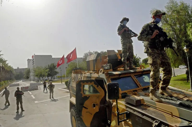 Soldiers stand on a tank outside Tunisia's parliament after President Saied closed it on July 25, 2021