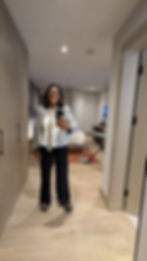 Jut landed in Kenya wearing black trousers, white shirt and jacket ready for a safari taken at Hyatt Nairobi