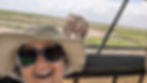 Safari hat, sunglasses, classic safari picture with an elephant walking behind the safari 4x4 vehicle