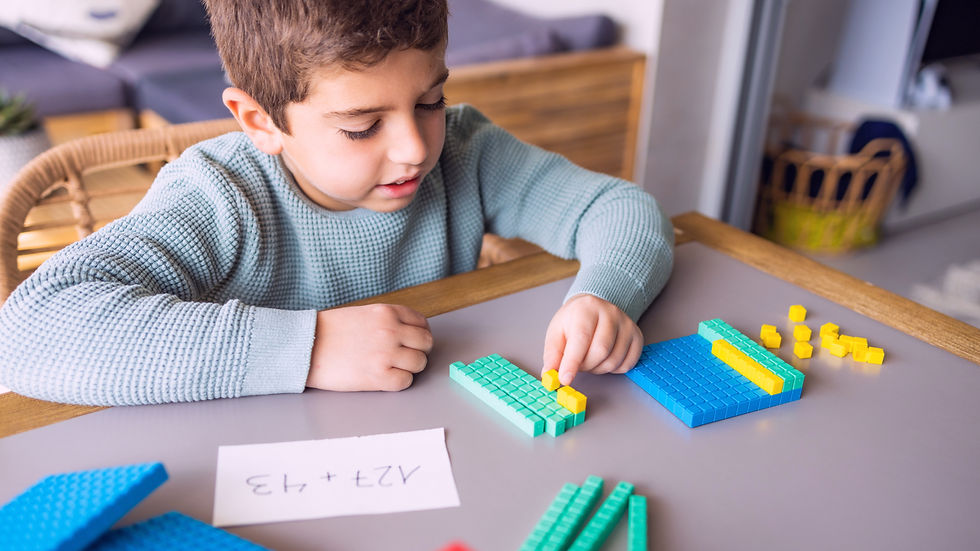 A young boy using base ten blocks for math