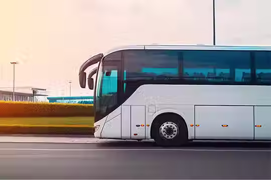 A modern luxury coach parked near the Promenade des Anglais in Nice, ready for group transport.