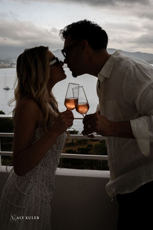 couple's drinking champagne in their hotel room on their honeymoon in Ibiza