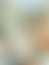 Woman sitting in meditation with hands at heart center and eyes closed