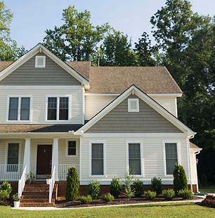 Front side of home with trees in the background.