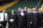 Alex Clark (center) with the Woodson High School Social Studies Department for graduation June 10, 2025.