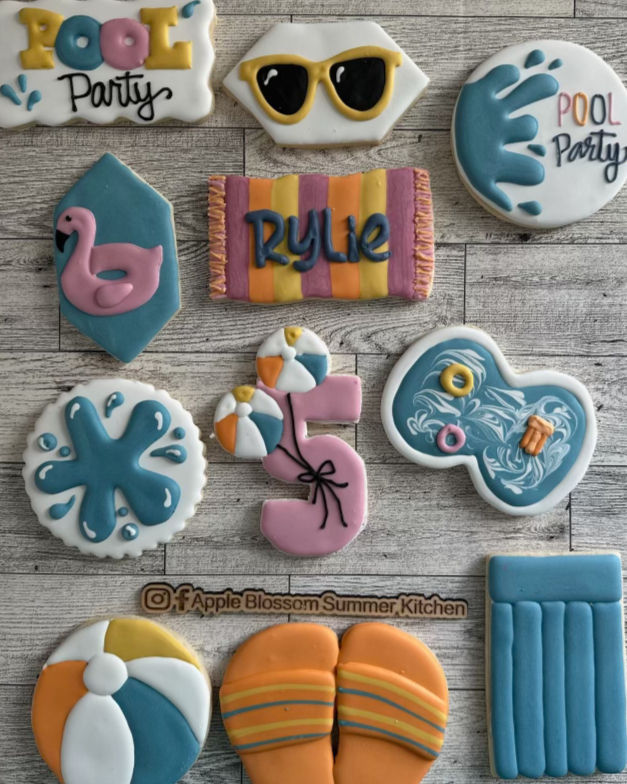 Thumbnail: Pool party cookies: 'POOL PARTY', sunglasses, flamingo, 'RYLIE', number 5, beach ball, flip-flops, and a raft.