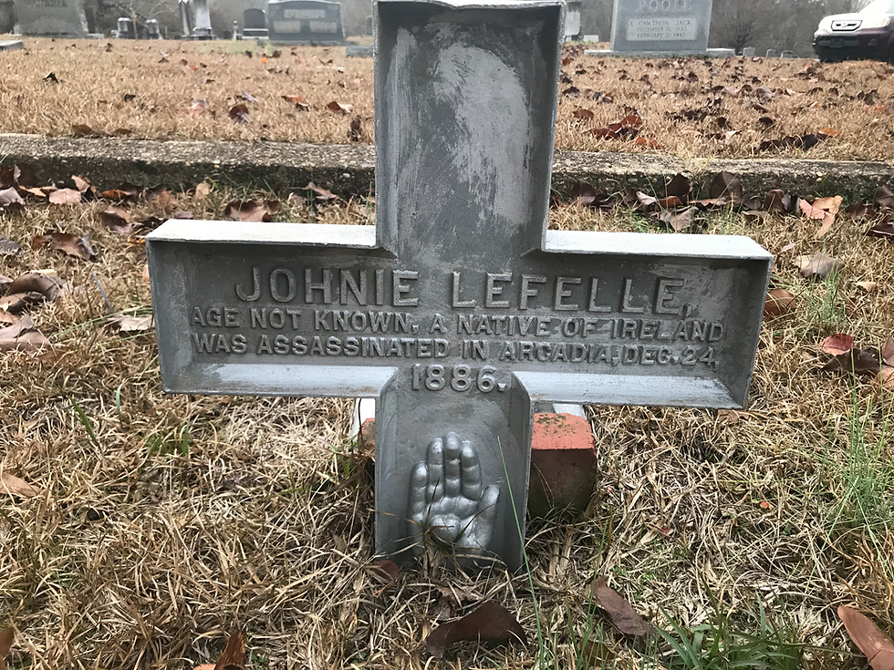 In Arcadia Cemetery, Arcadia, Louisiana, a metal cross marks the final resting place of Johnie Lafelle, and labels him a victim of assassination. Courtesy of Tarah Thomas