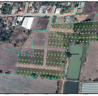 Technical blueprint and master plan layout over a satellite image showing the sub-divided lots and internal streets for the real estate development in Baja Verapaz.